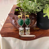 Vriksham Dual Tone Deer & Elephant Motif Jhumkas With Green Teardrop Stone Earrings-S1091