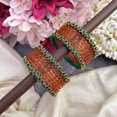 Vriksham Starry Bloom Orange Glass Bangles with Floral Emerald Kundan Work-G19838